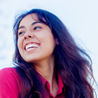 A women in pink color shirt smiling
