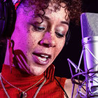 A lady singer is singing on mic